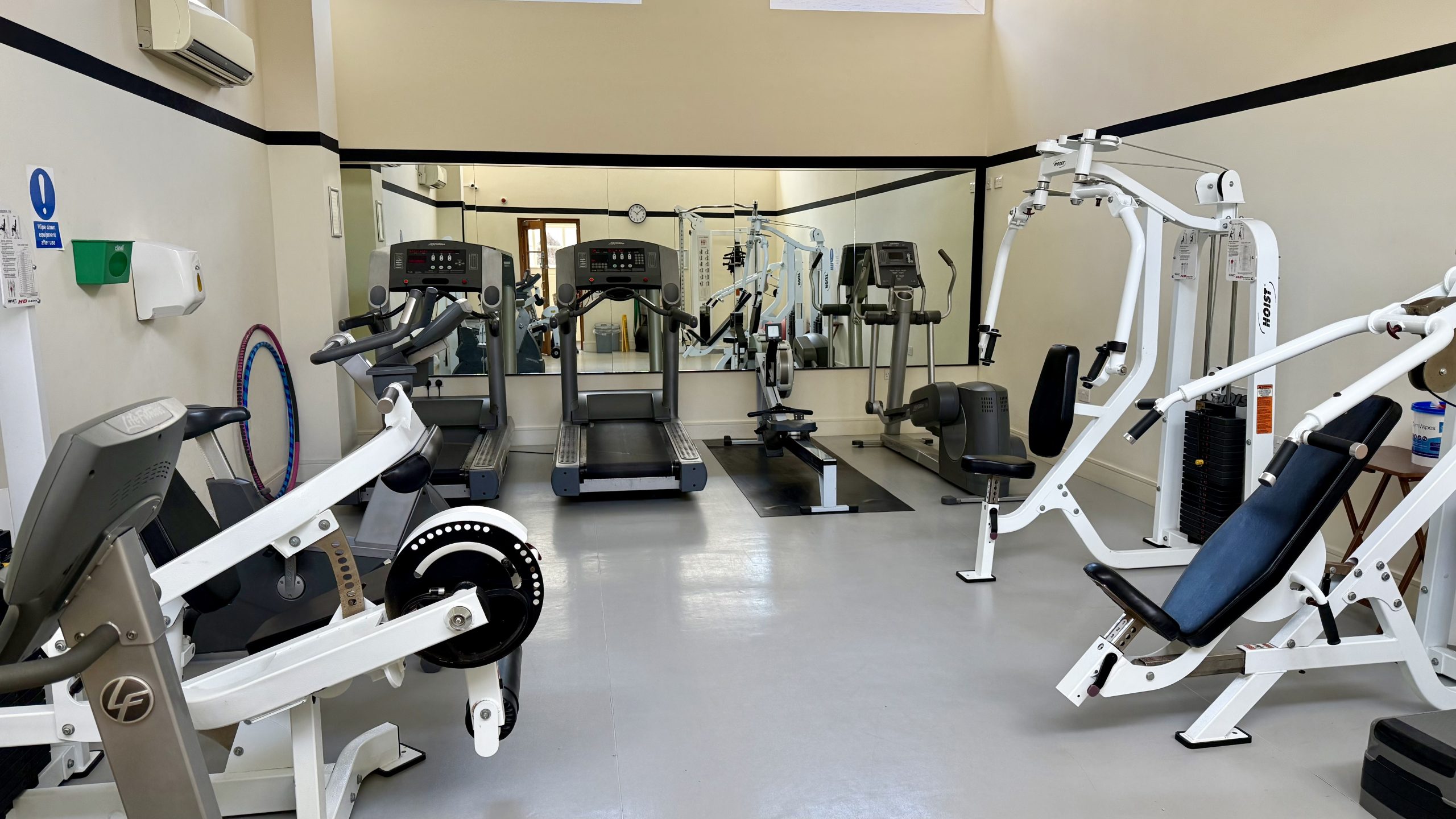 Hayes Point residents’ gym with treadmills, rowing machine, and weight station.